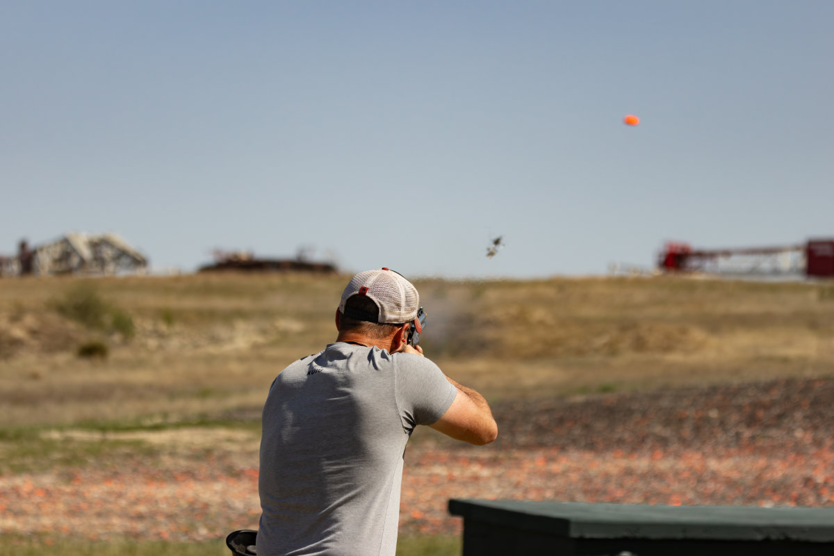 Shooter on the trap line with a clay in the air